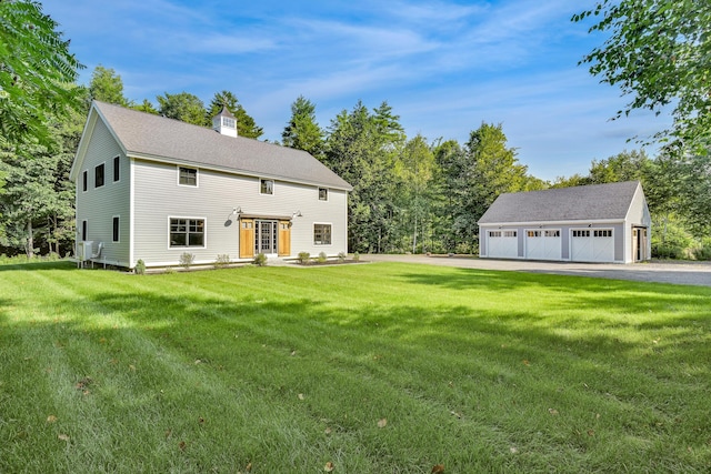 view of front of property featuring an outbuilding, a garage, and a front lawn