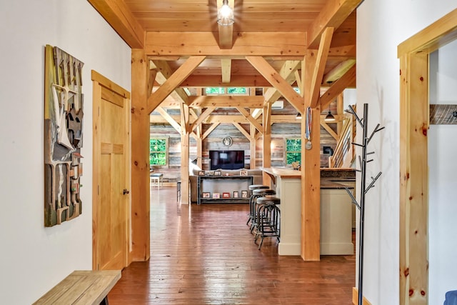 interior space with beamed ceiling and dark wood-type flooring