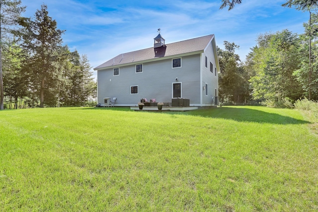 rear view of house with a yard