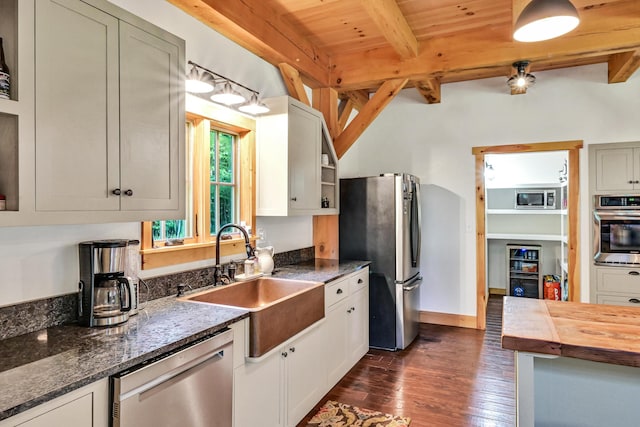 kitchen with butcher block countertops, sink, dark hardwood / wood-style flooring, wood ceiling, and stainless steel appliances