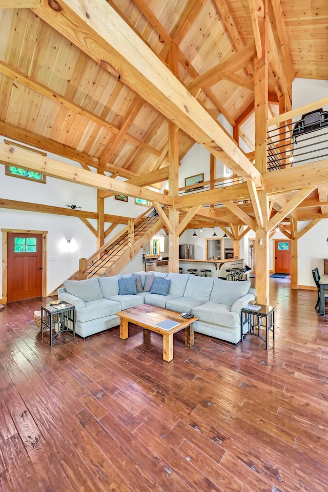 living room with wood ceiling, hardwood / wood-style flooring, and beamed ceiling