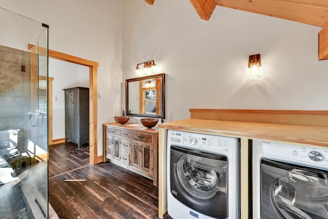 laundry area featuring independent washer and dryer and dark hardwood / wood-style flooring