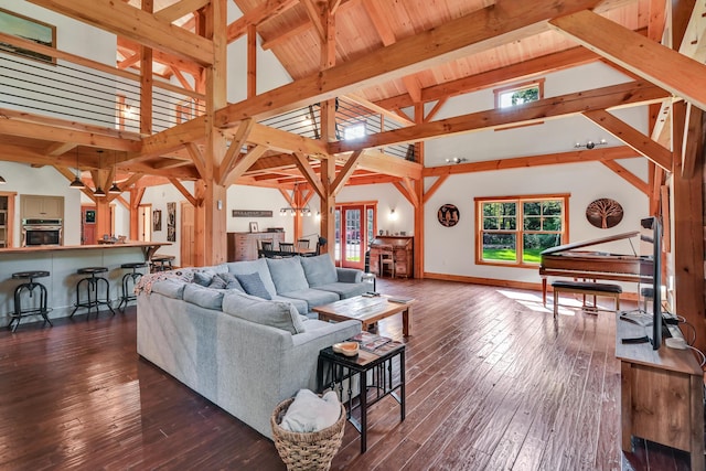 living room featuring dark hardwood / wood-style flooring, high vaulted ceiling, and beamed ceiling