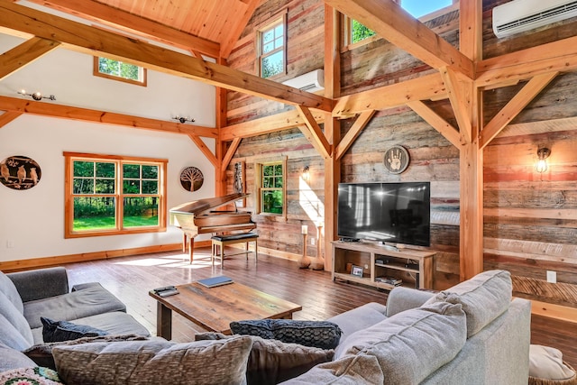 living room with a wall mounted air conditioner, wood-type flooring, and a healthy amount of sunlight