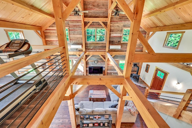 interior space featuring vaulted ceiling with beams, wood ceiling, wood-type flooring, and ceiling fan