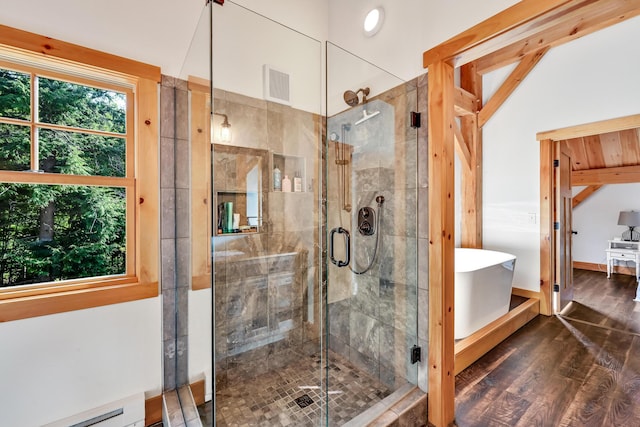 bathroom with a baseboard radiator, lofted ceiling, plus walk in shower, and wood-type flooring