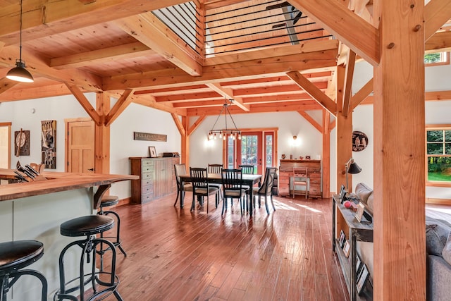 dining space featuring hardwood / wood-style flooring, wooden ceiling, and beam ceiling