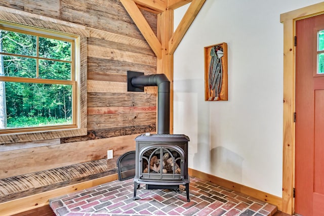 room details featuring wood walls and a wood stove