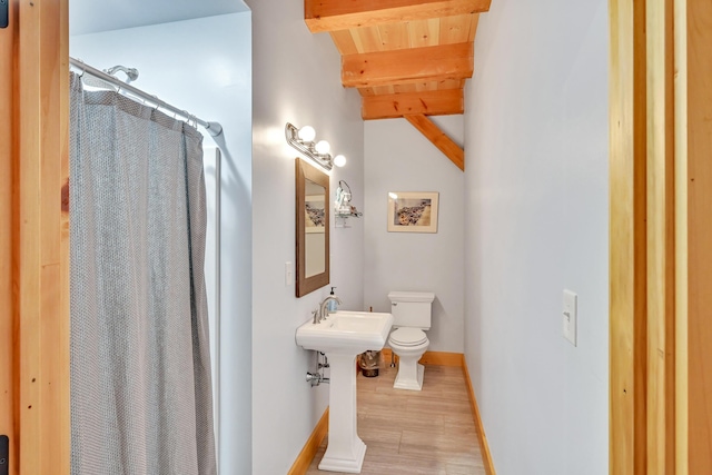 bathroom featuring hardwood / wood-style floors, wood ceiling, toilet, beam ceiling, and a shower with shower curtain