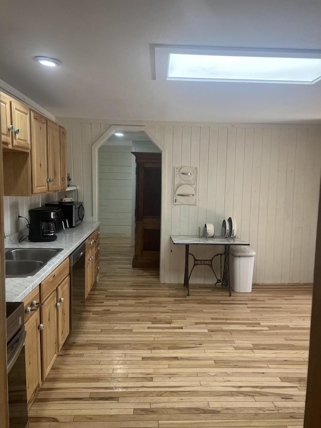 63 Rebel Hill Rd, Merrill, ME 04780 - kitchen with light wood finished floors, arched walkways, a sink, stainless steel appliances, and light countertops
