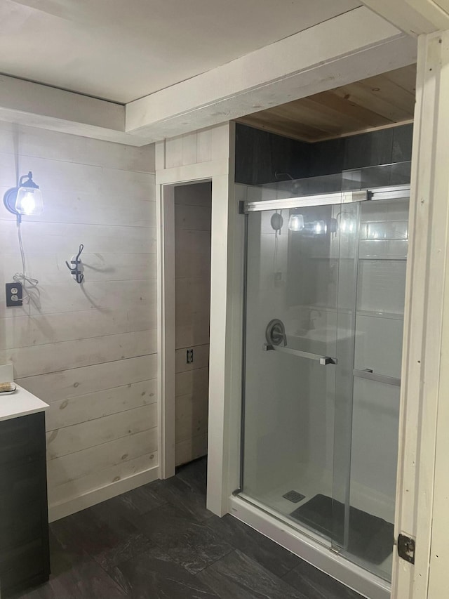 63 Rebel Hill Rd, Merrill, ME 04780 - full bathroom featuring wood walls, a stall shower, and vanity