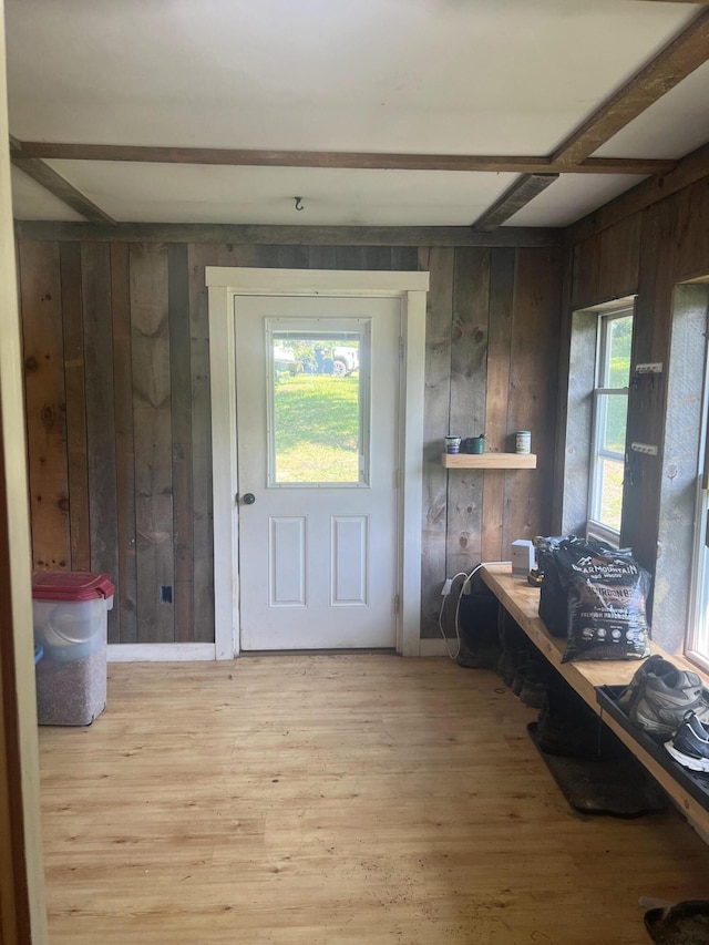 63 Rebel Hill Rd, Merrill, ME 04780 - doorway to outside with beamed ceiling, plenty of natural light, wooden walls, and wood finished floors