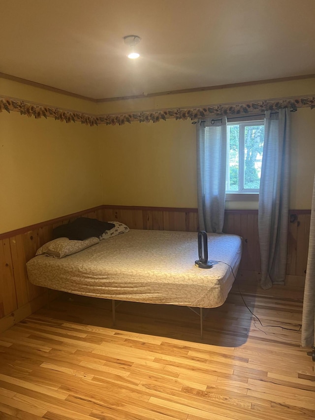 63 Rebel Hill Rd, Merrill, ME 04780 - bedroom with light wood finished floors, a wainscoted wall, and crown molding