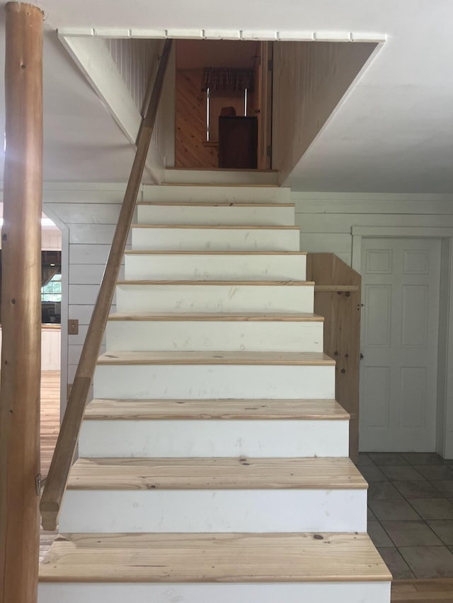 63 Rebel Hill Rd, Merrill, ME 04780 - stairs with wooden walls and tile patterned flooring