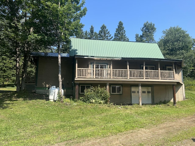 63 Rebel Hill Rd, Merrill, ME 04780 - view of front facade with a front lawn, an attached garage, driveway, and metal roof