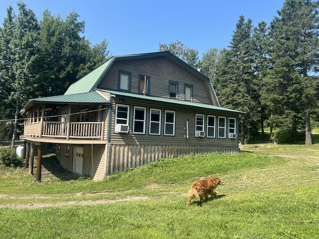 63 Rebel Hill Rd, Merrill, ME 04780 - view of home's exterior with a gambrel roof, cooling unit, and a yard