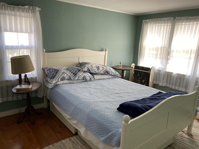 bedroom with multiple windows and wood-type flooring