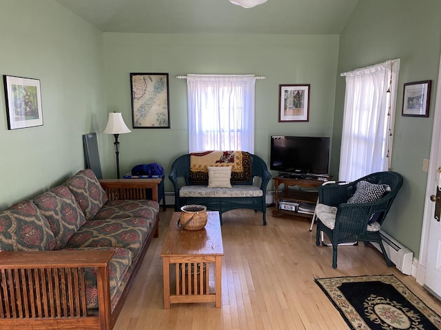living room with light wood finished floors, a baseboard radiator, and baseboard heating
