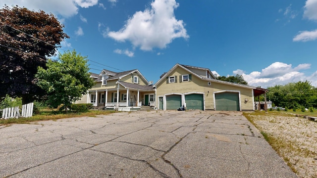 view of front of house with a porch and a garage