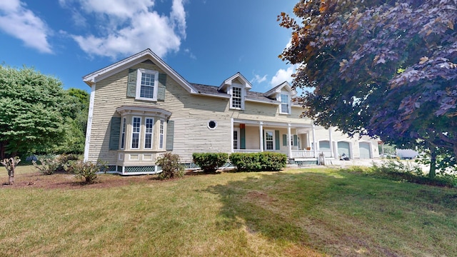 view of front of property with covered porch and a front lawn