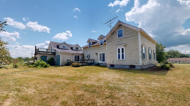 rear view of house featuring a yard and a deck