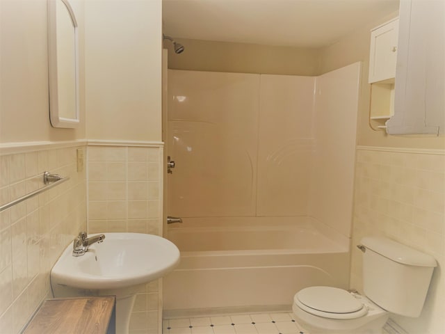 27 Wesley St, Bath, ME 04530 - bathroom featuring tile walls, toilet, bathing tub / shower combination, and a wainscoted wall
