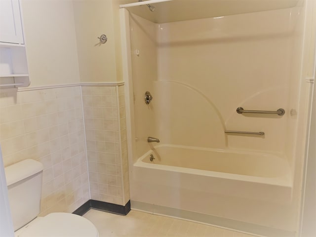 27 Wesley St, Bath, ME 04530 - bathroom featuring toilet, shower / washtub combination, tile walls, and wainscoting