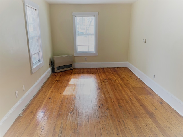 27 Wesley St, Bath, ME 04530 - spare room with heating unit, light wood-style floors, and baseboards