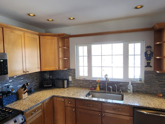 kitchen with a healthy amount of sunlight, sink, dishwasher, and backsplash