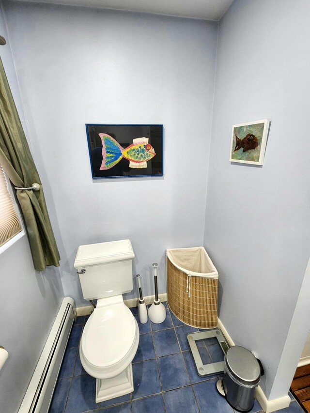 bathroom with tile patterned flooring, a baseboard heating unit, and toilet