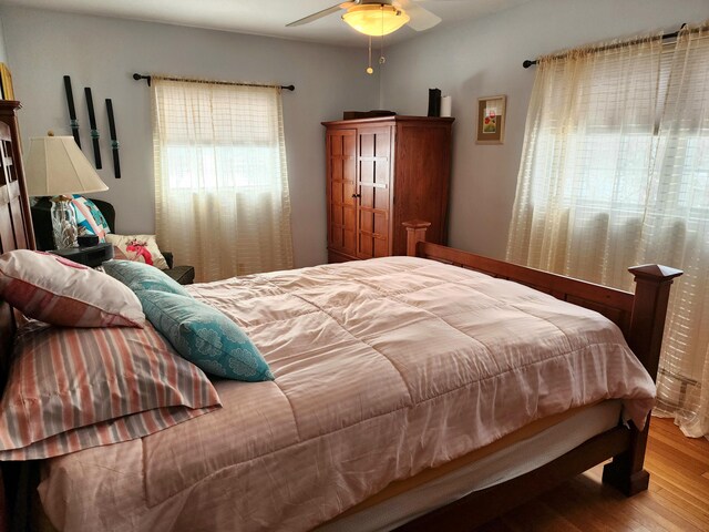 bedroom with wood-type flooring and ceiling fan