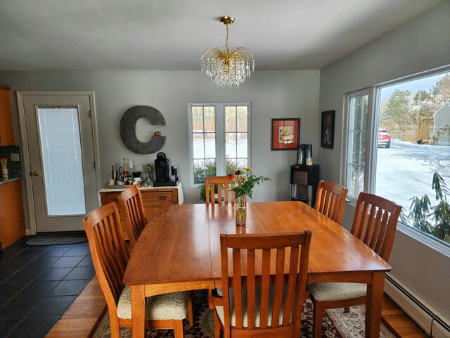 tiled dining area featuring a baseboard radiator and a chandelier