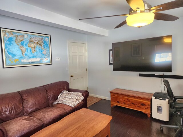living area with baseboards, ceiling fan, and wood finished floors