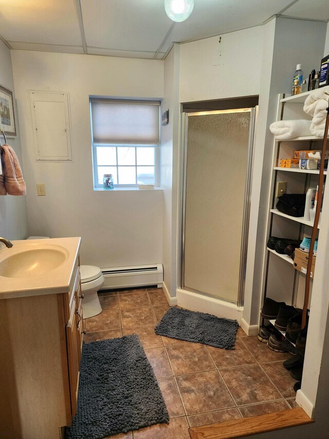 bathroom with vanity, tile patterned floors, walk in shower, a baseboard radiator, and toilet