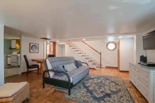 living room featuring visible vents, stairway, and baseboards