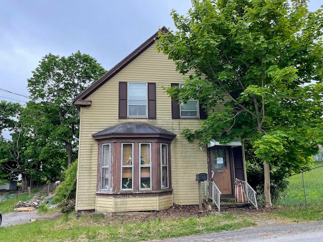 view of front of house featuring entry steps and fence