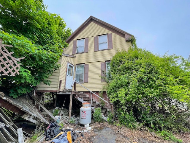 back of house with stairs