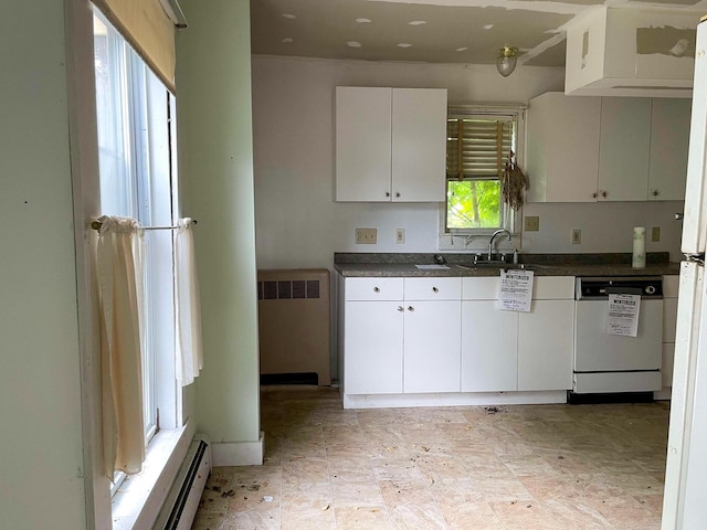 kitchen featuring dark countertops, radiator heating unit, a baseboard heating unit, a sink, and dishwasher