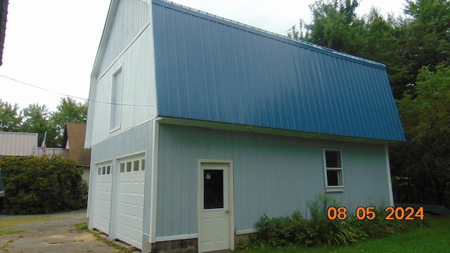 view of side of property with a garage and an outdoor structure