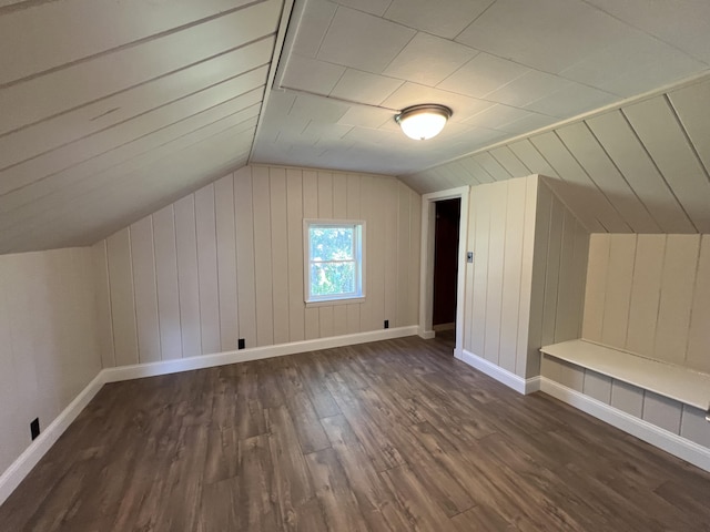 bonus room with lofted ceiling and dark wood-type flooring