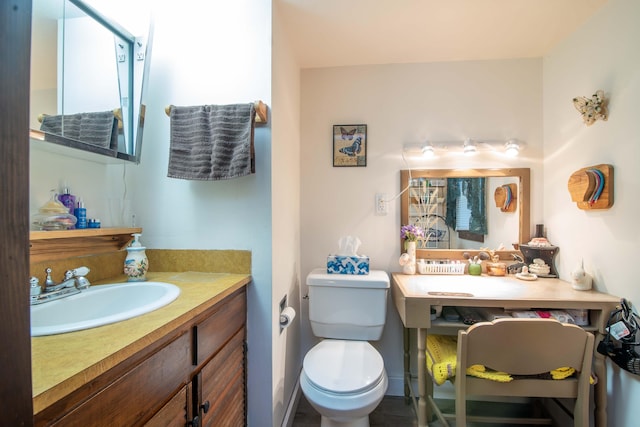 bathroom with toilet and vanity