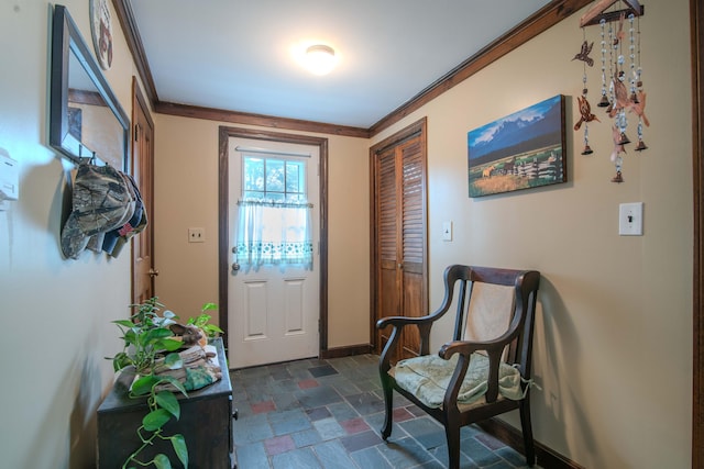 doorway to outside featuring dark tile patterned flooring and crown molding