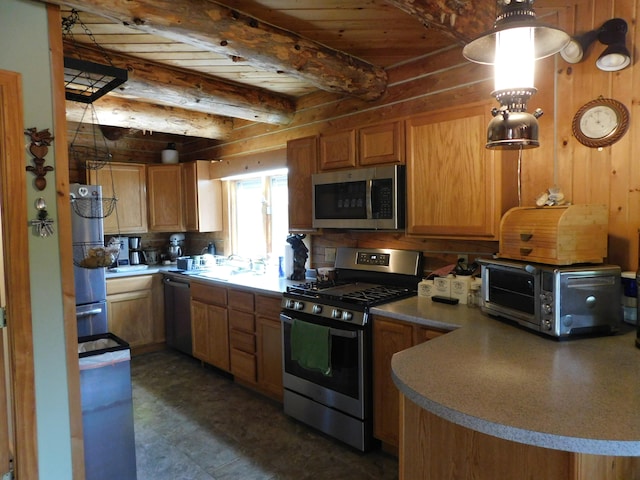 kitchen featuring beam ceiling, sink, and stainless steel appliances