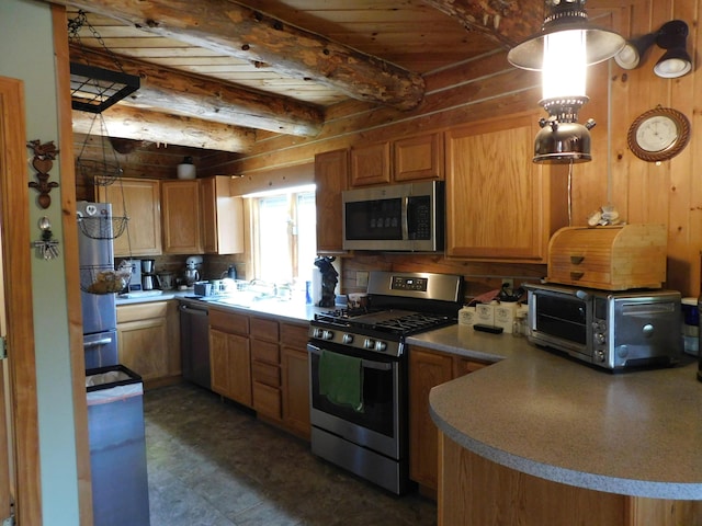 61 Sawyer Pond Highlands, Greenville, ME 04441 - kitchen with beamed ceiling, stainless steel appliances, a toaster, and a sink