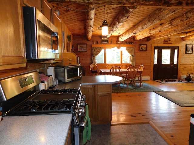 kitchen with appliances with stainless steel finishes, wood ceiling, hardwood / wood-style flooring, and lofted ceiling with beams