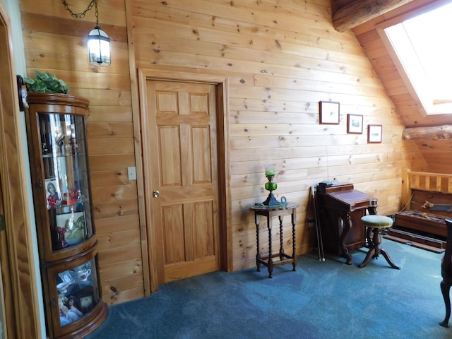 interior space with lofted ceiling with skylight, carpet flooring, and wood walls