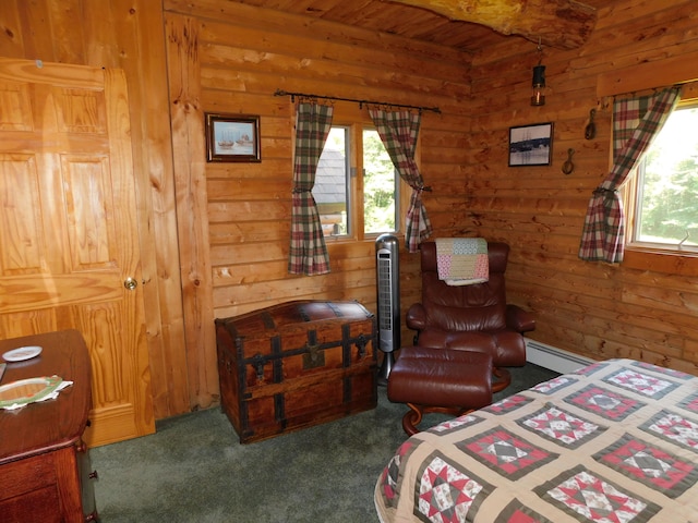 carpeted bedroom featuring wood walls, multiple windows, and a baseboard radiator