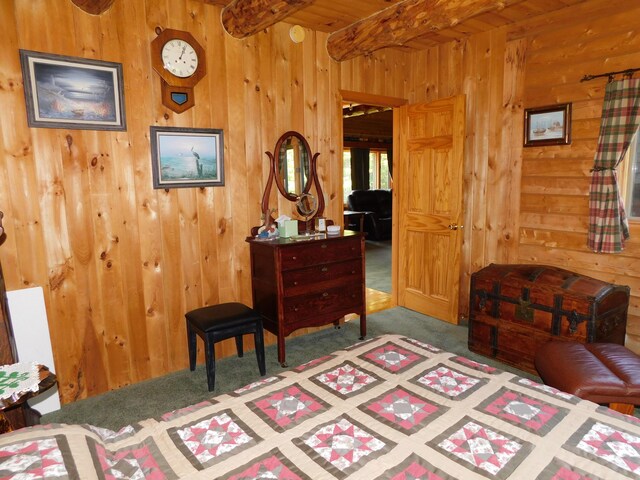 61 Sawyer Pond Highlands, Greenville, ME 04441 - carpeted bedroom with wood walls and beamed ceiling
