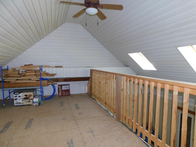 additional living space featuring vaulted ceiling with skylight and ceiling fan