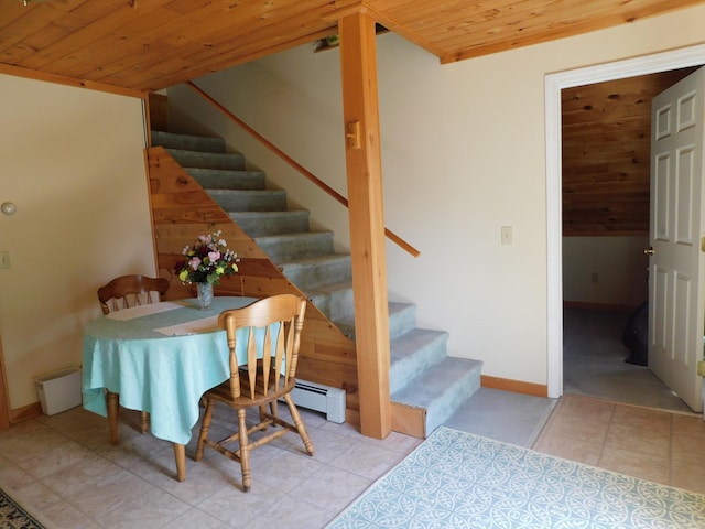 tiled dining area with wooden ceiling and a baseboard radiator